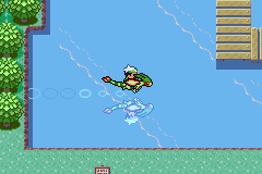 The player surfing across water near trees and a wooden dock, viewed from above