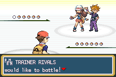 A battle about to start on a sandy arena: two trainers in caps stand opposite the player under the line "TRAINER RIVALS would like to battle!"
