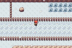 A snowed-over cave floor with icy pillars and bare branches, the player standing in the middle of it
