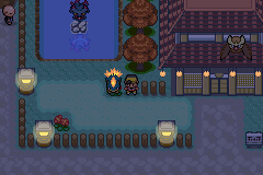 A town at night lit by lamps, with Cyndaquil following the player