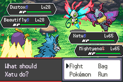 A double battle in a forest: Dustox and Beautifly on the far side, Xatu and Mightyena on the player's side, with the fight menu open