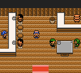 The inside of a wooden building with several people standing between the counters