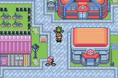 A city street with a Pokémon Centre and a bike shop, racks of bicycles outside and a rider passing the player