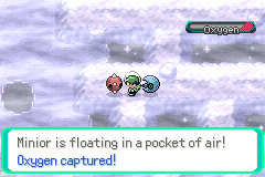 A Minior floating in a captured pocket of air underwater, with the text reading Minior is floating in a pocket of air! Oxygen captured!