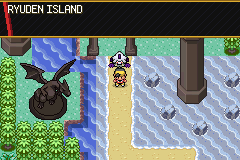 A beach on Ryuden Island with a large dark dragon statue beside the path